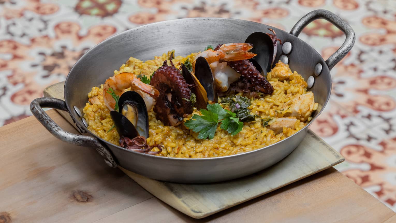 A metal pan with rice and seafood.