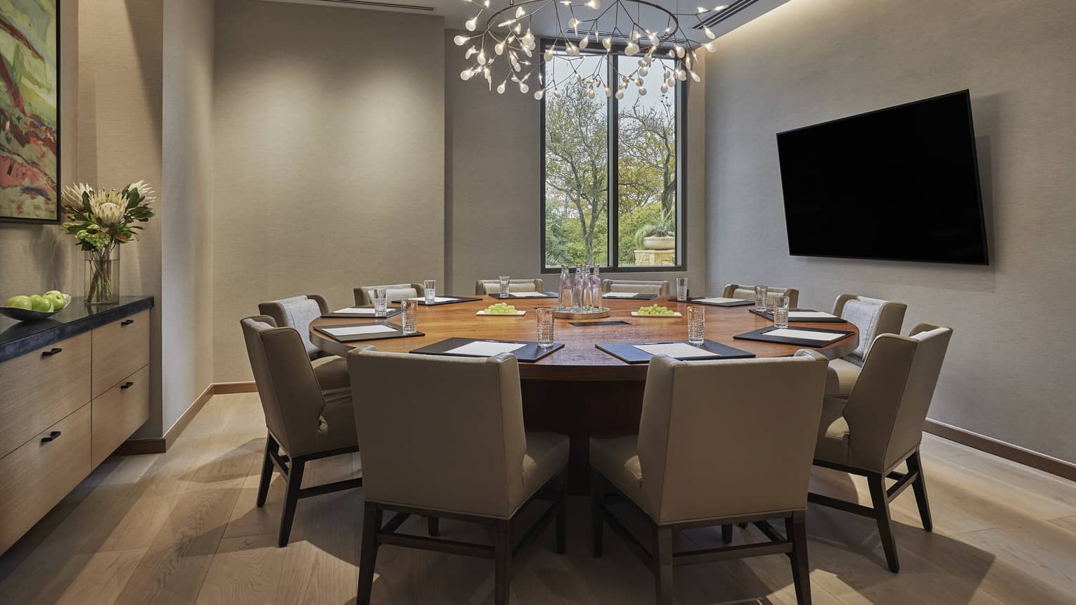 Shoal Creek meeting room with small round table, large chairs, screen
