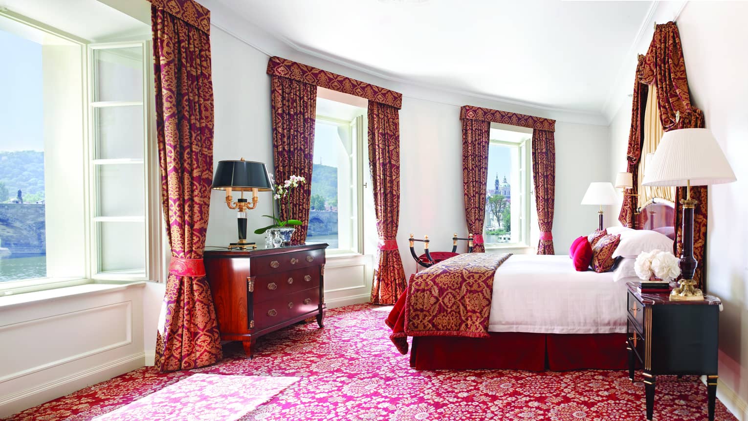 Presidential Suite with bright windows along curved wall, Baroque-inspired red-and-gold carpet, curtains