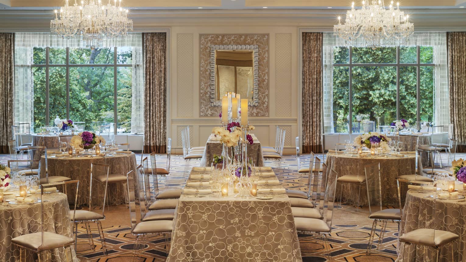 Ballroom Social setup with tables, chairs under two large windows, crystal chandeliers 