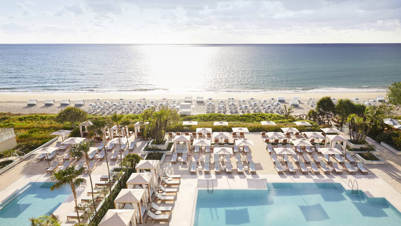 Aerial view of sprawling Four Seasons Resort Palm Beach pool, patio and beach by ocean