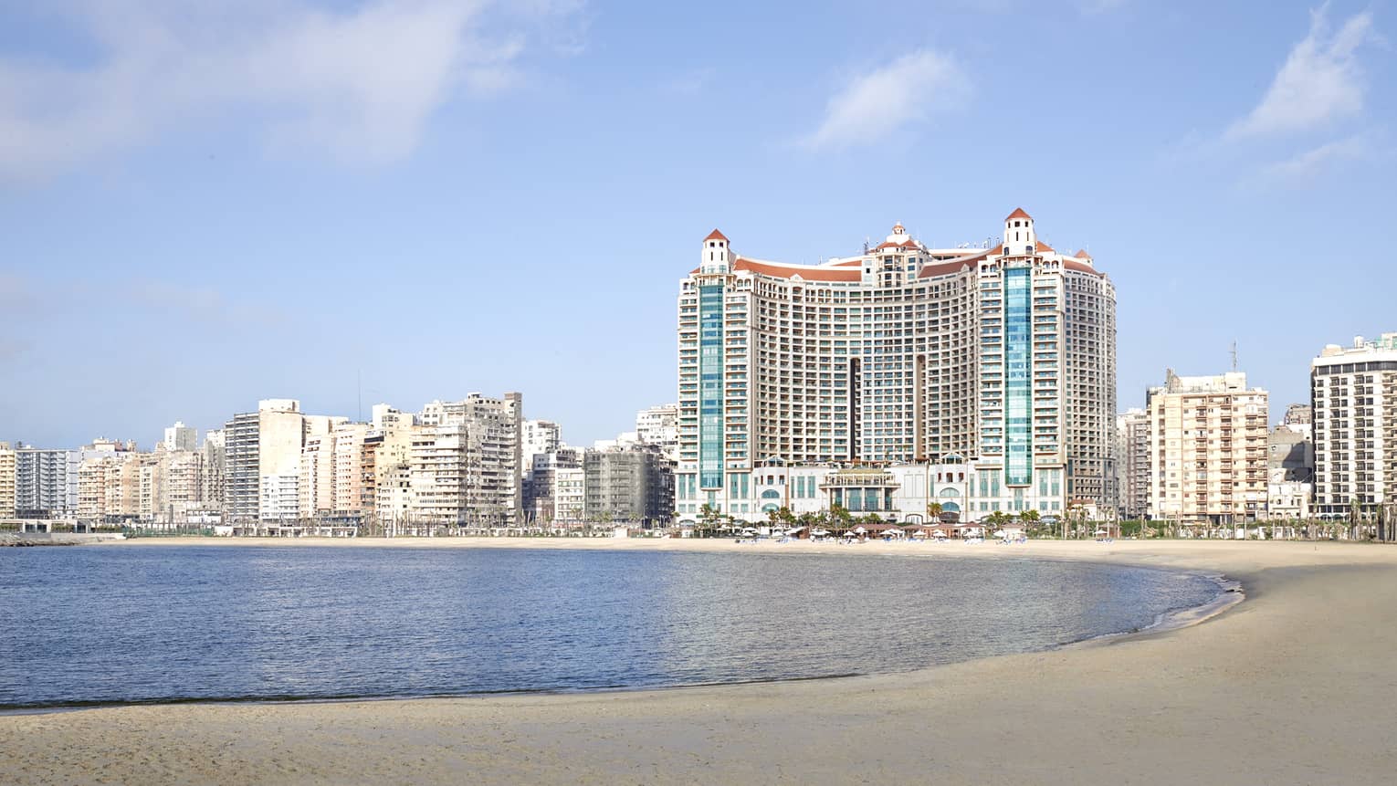 Hotel exterior against backdrop of the city on the beach