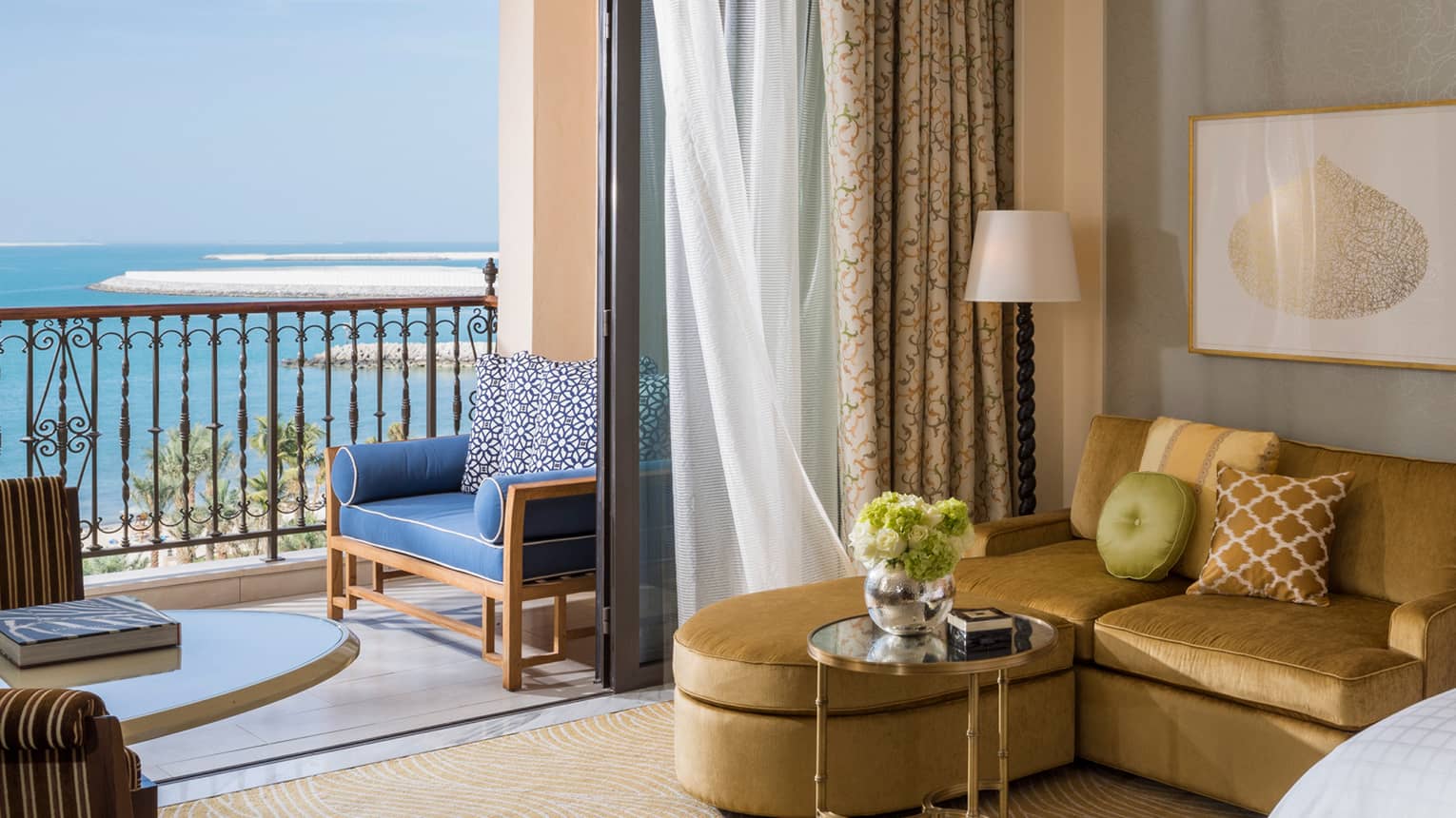 Premier Sea-View Room with L-shaped gold sofa beside oversized sliding glass door to balcony