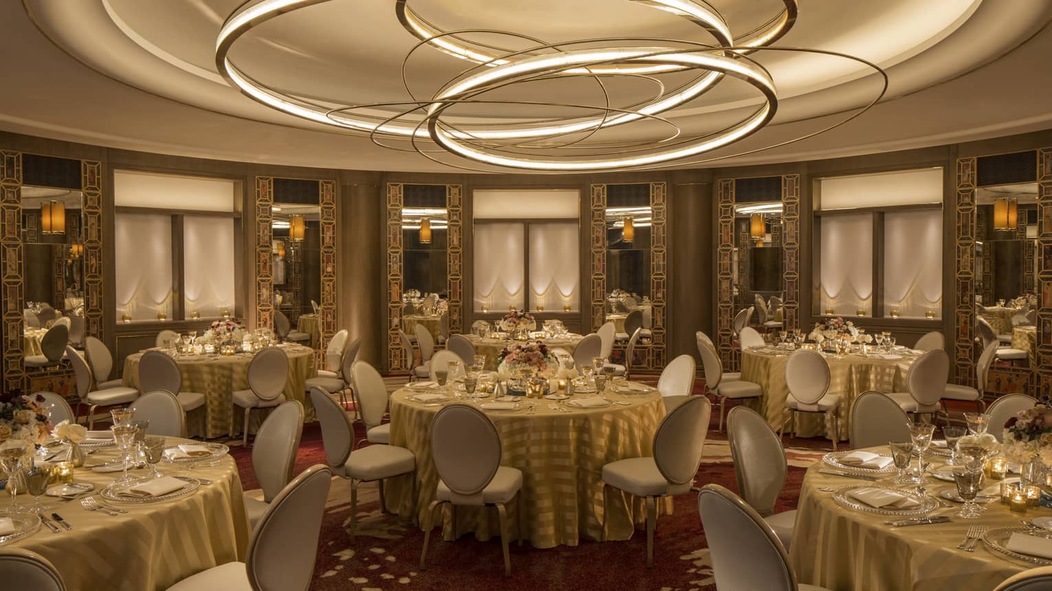 Merchants Hall banquet tables in round event room with recessed ceiling with modern gold disc sculptures 