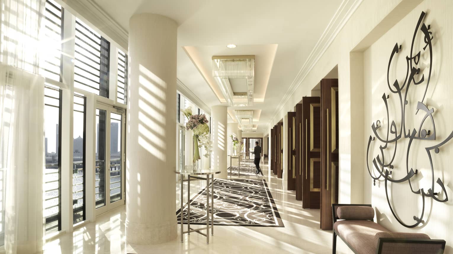 Sunlight streams into bright Al Maryah Ballroom event space with white marble pillar, hall