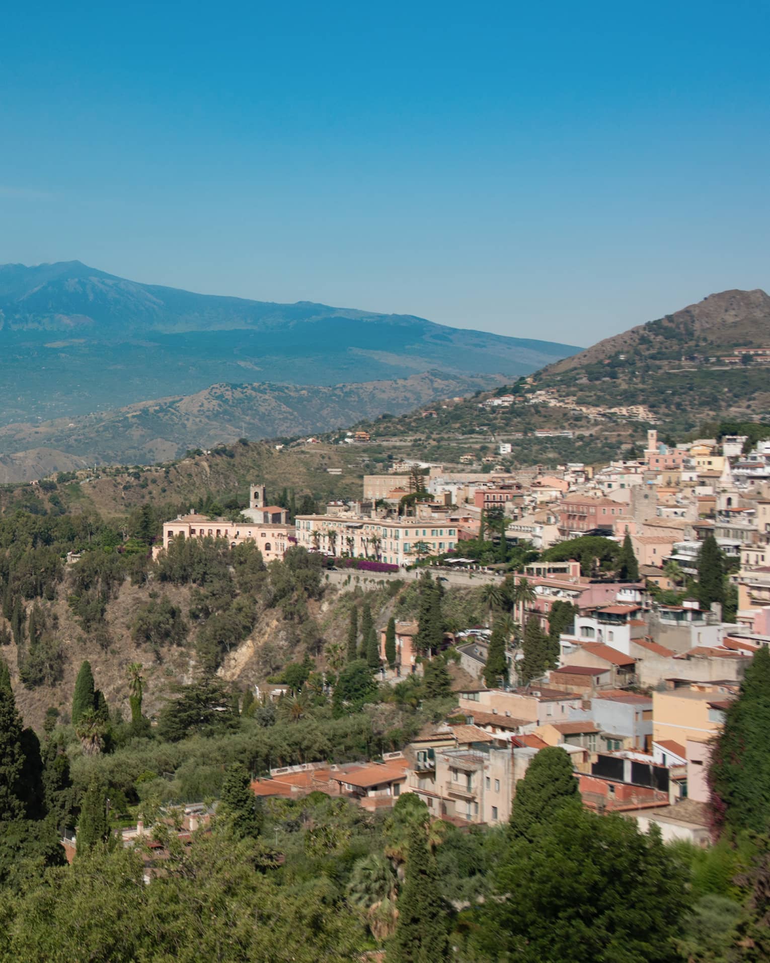 View of Taormina town on hillside, overlooking the sea