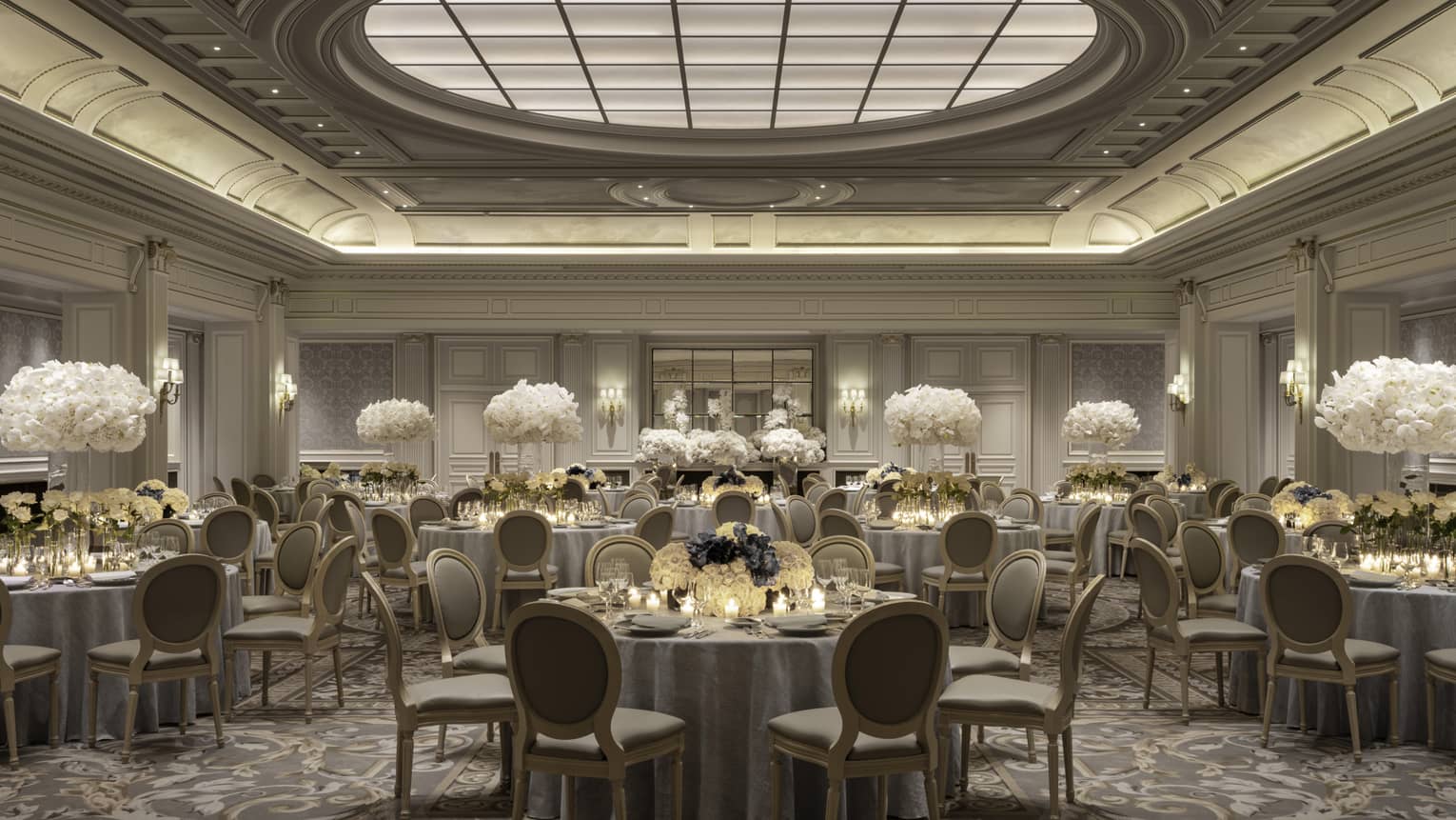 Elegant Paris banquet room, dining tables with white floral centrepieces under decorative domed ceiling