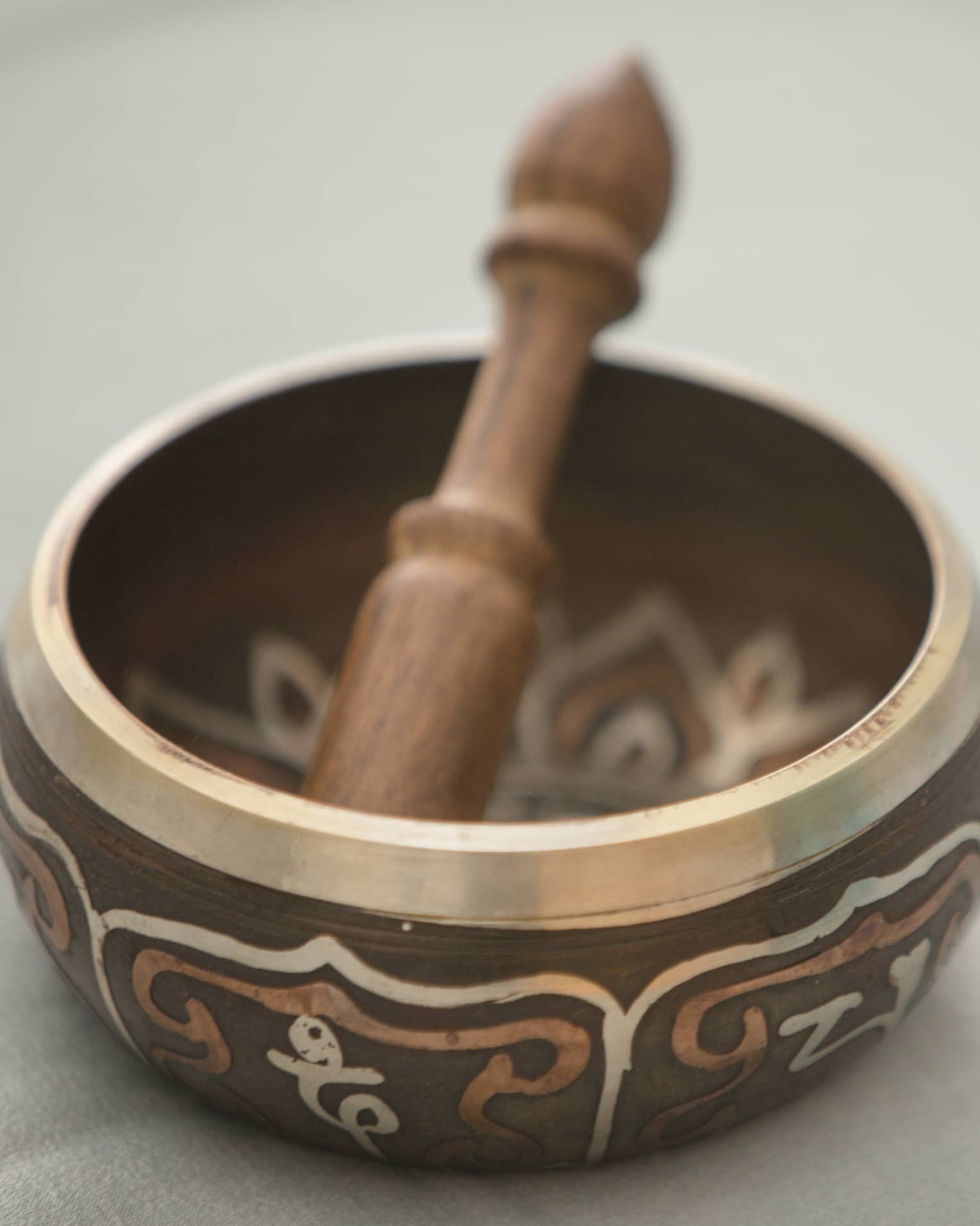 Small copper and wood bowl with decorative design, wood pestle