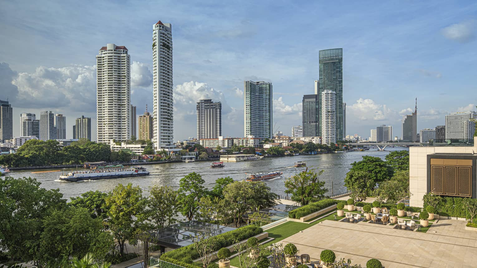 Outdoor terrace with landscaping around edge, view of Chao Phraya River in Bangkok