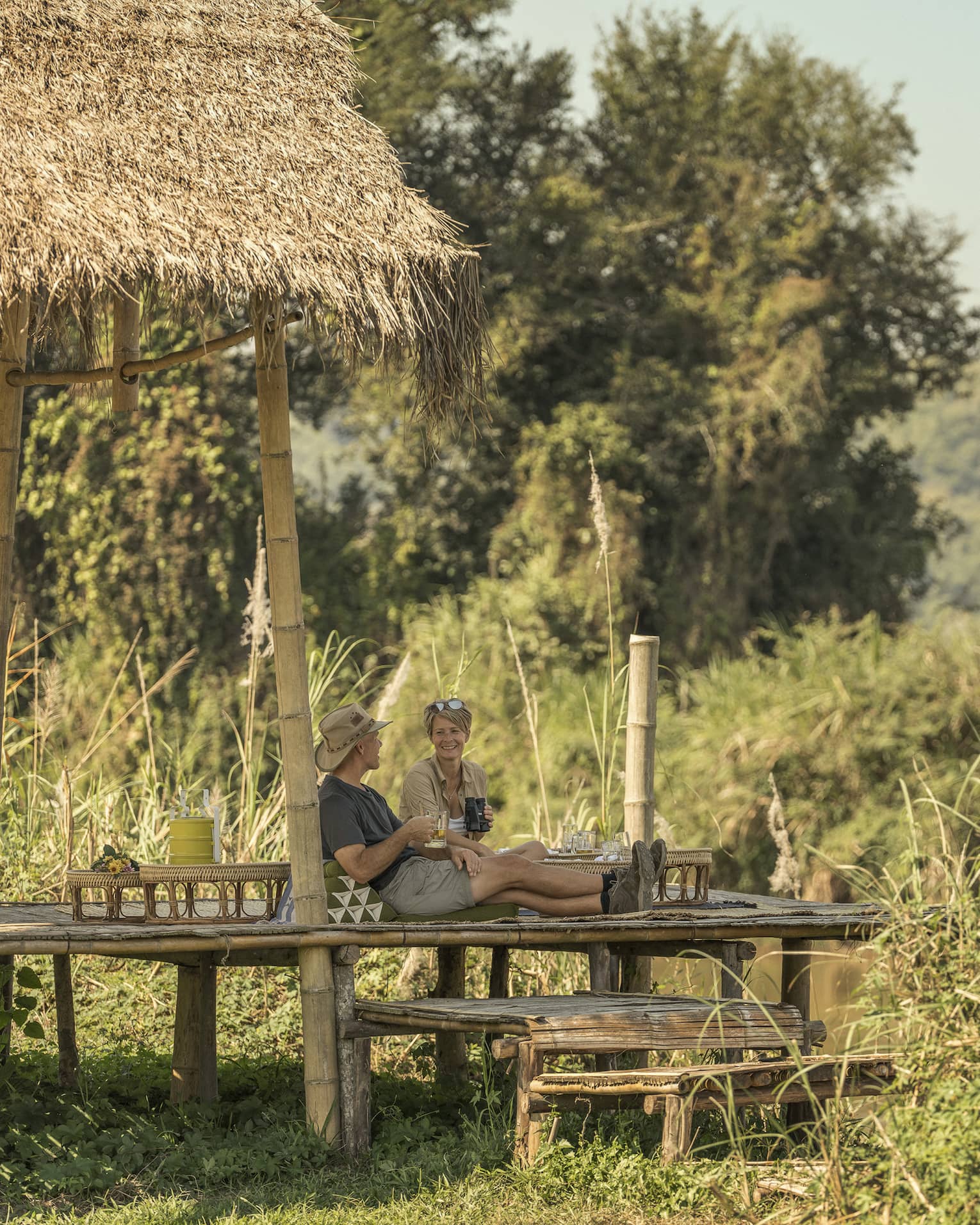 Couple enjoys a camp picnic in the Thai wilderness