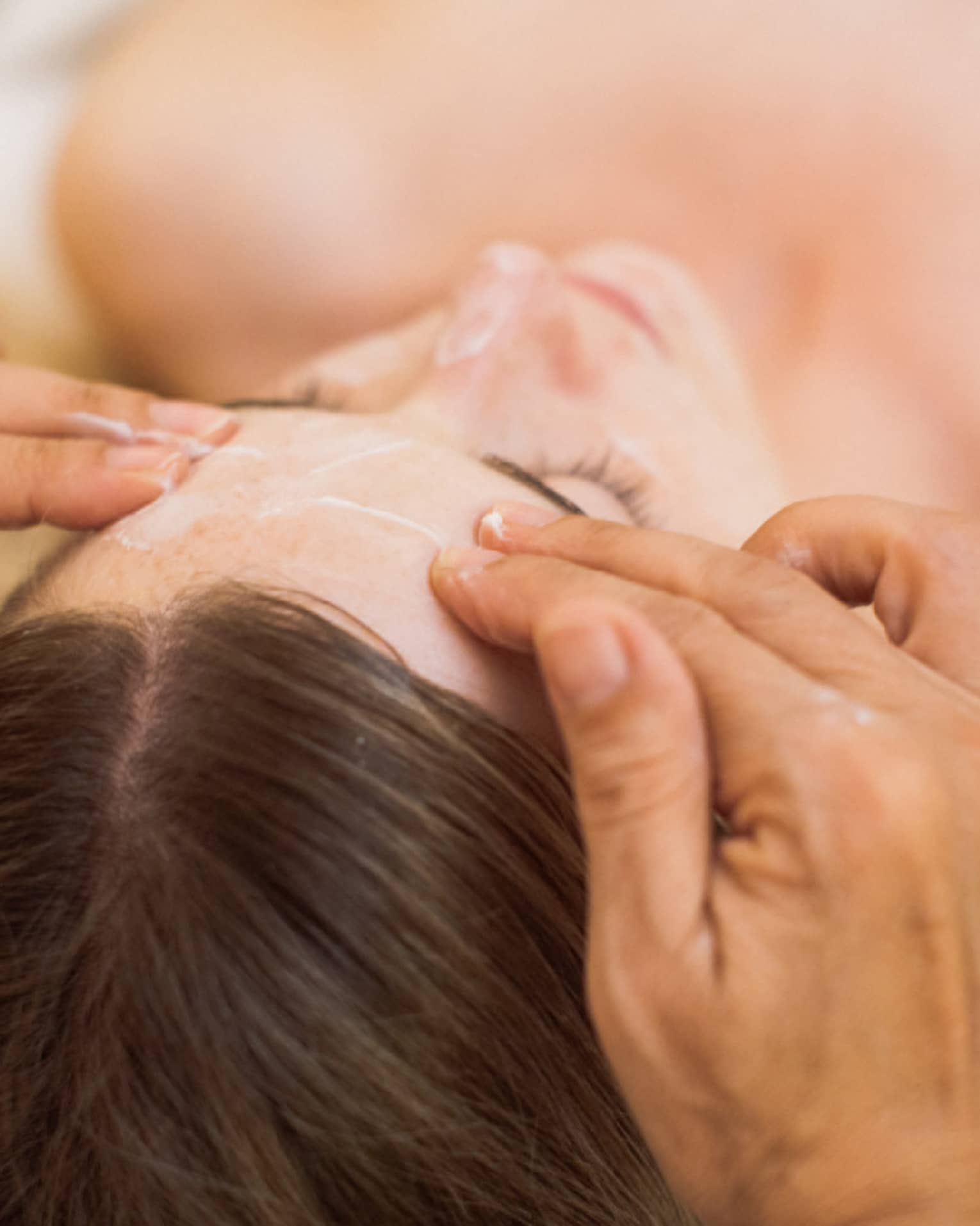 A guest is treated to a calming facial at the spa