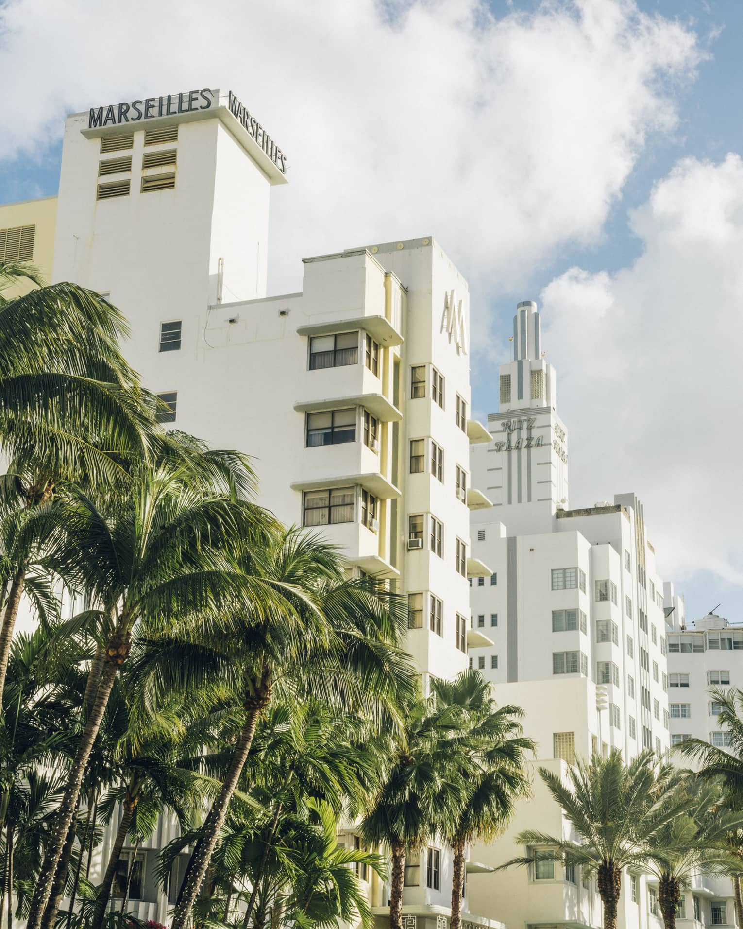 Several hotels in Art Deco buildings are landscaped with palm trees on Collins Avenue.
