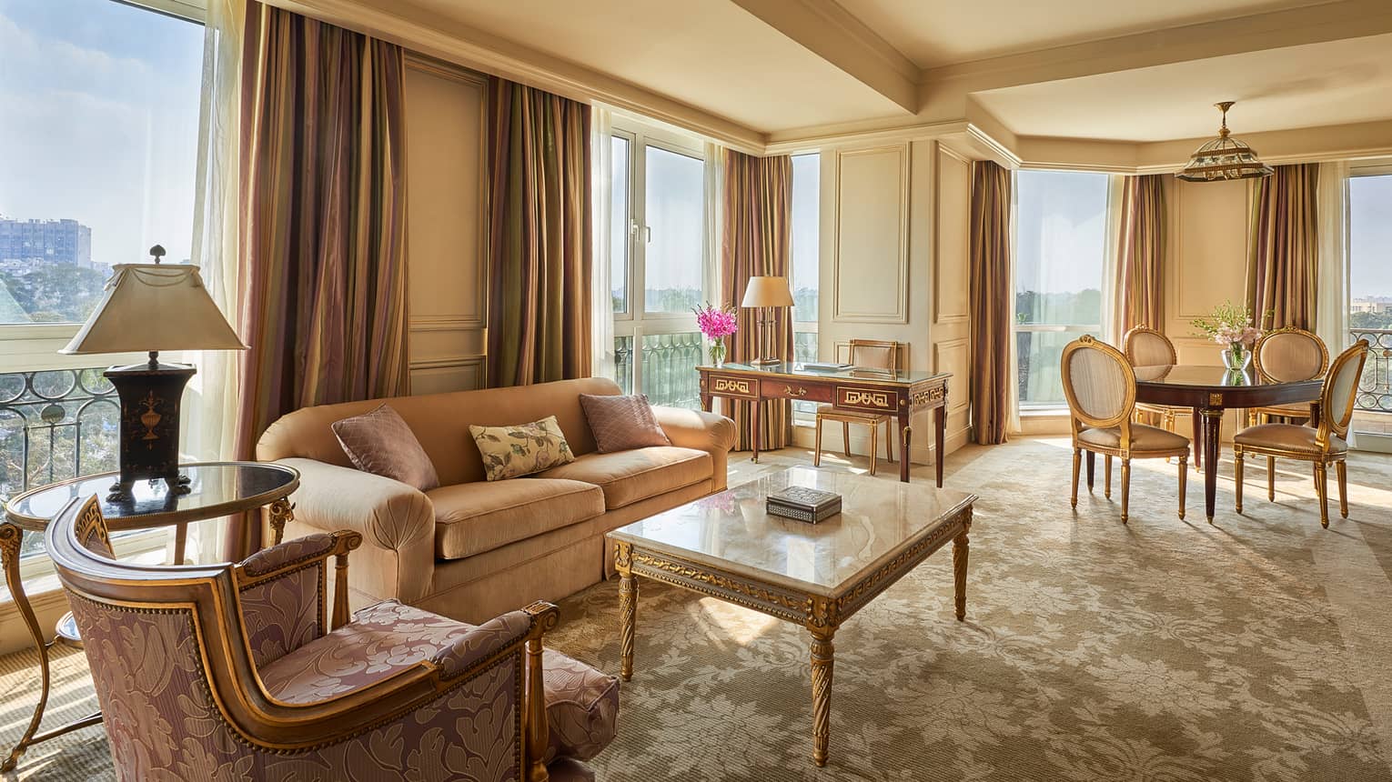 Diplomatic Suite corner living room with pink and cream-coloured sofas, carpets, rug and curtains