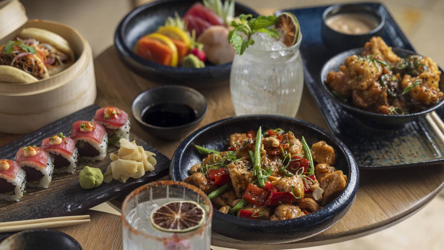 Table filled with an assortment of food and cocktails