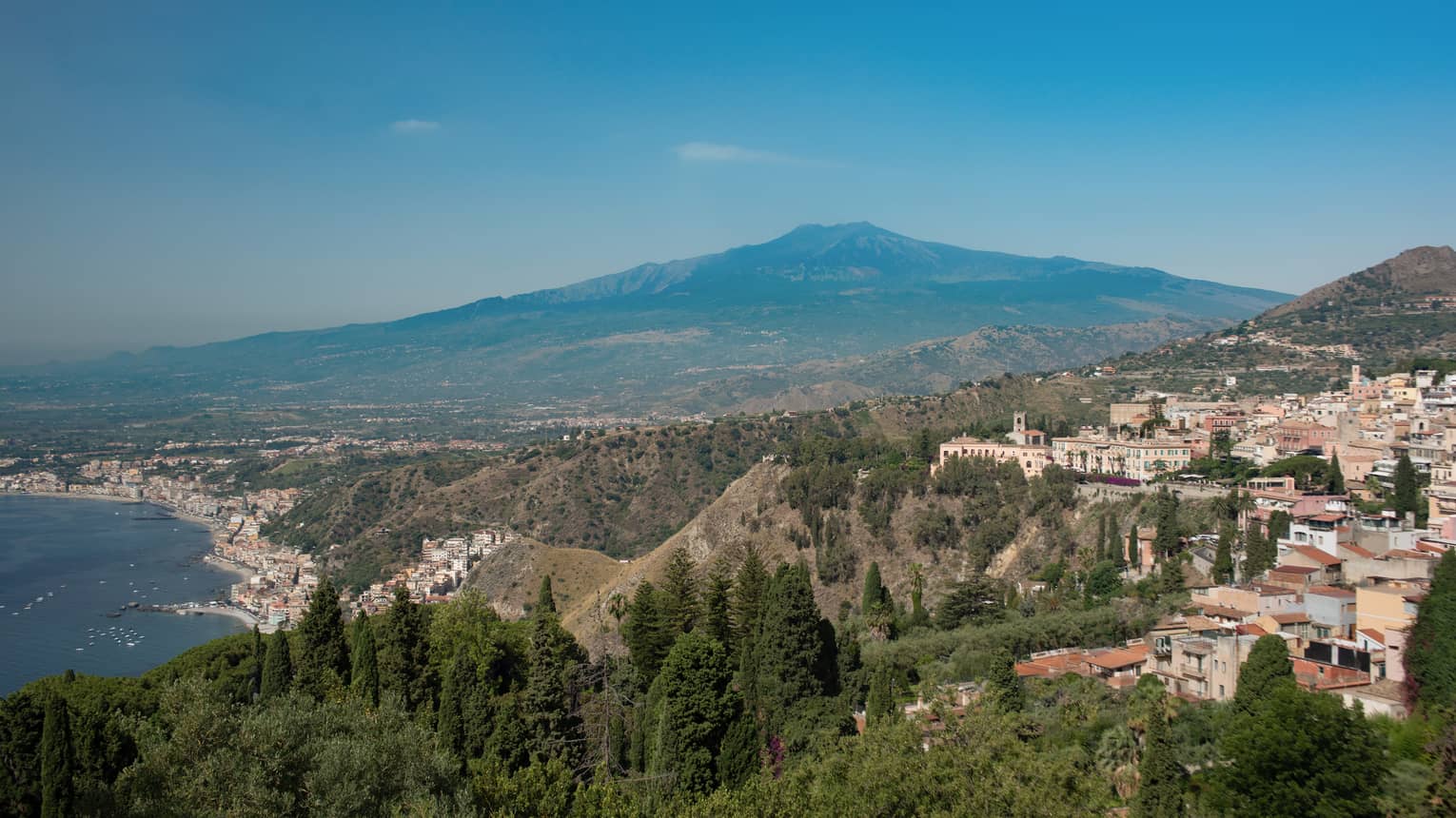 View of Taormina town on hillside, overlooking the sea