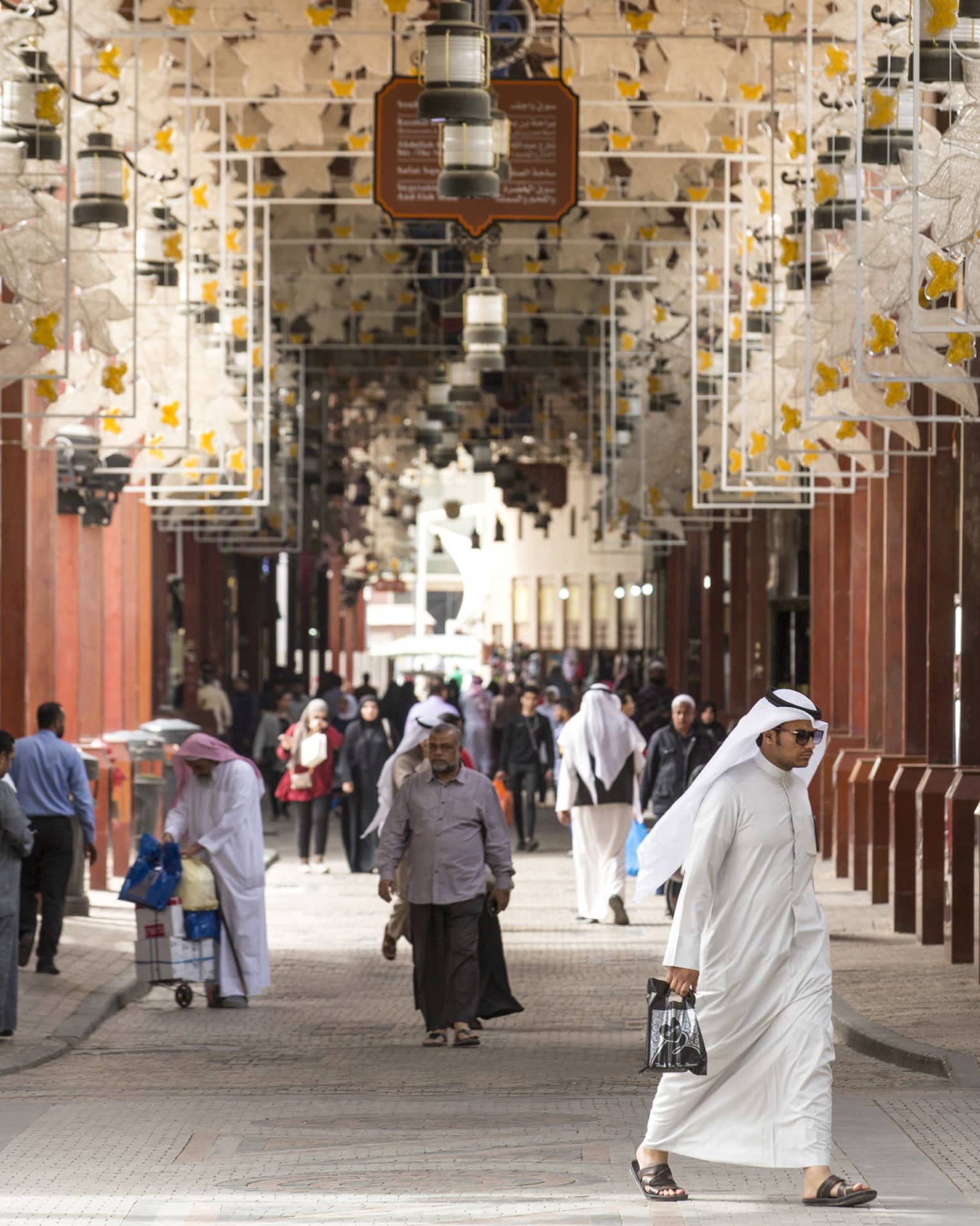 Shoppers walking through Souk al Mubarakiya 