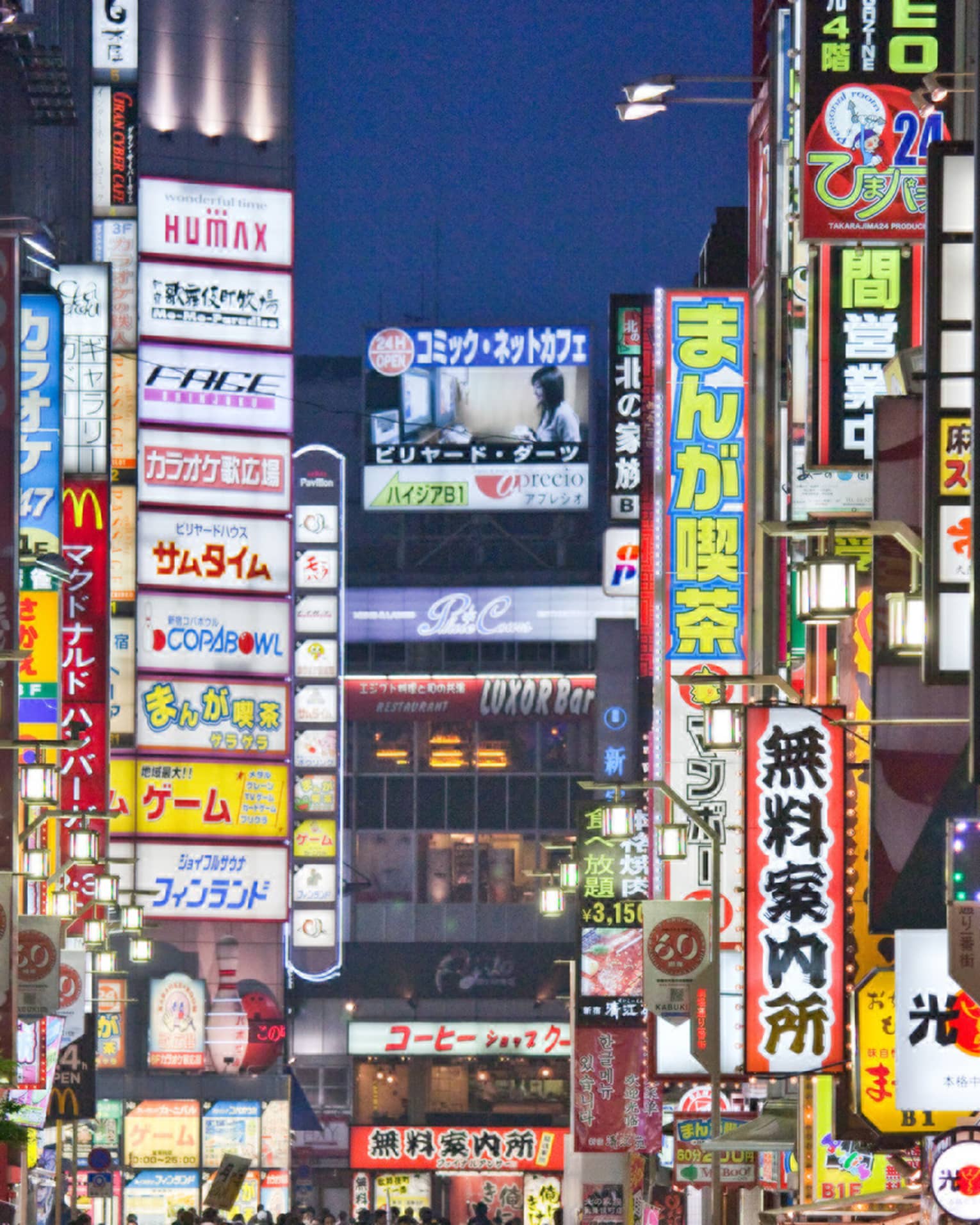 Crowds under Tokyo lights, colourful billboards