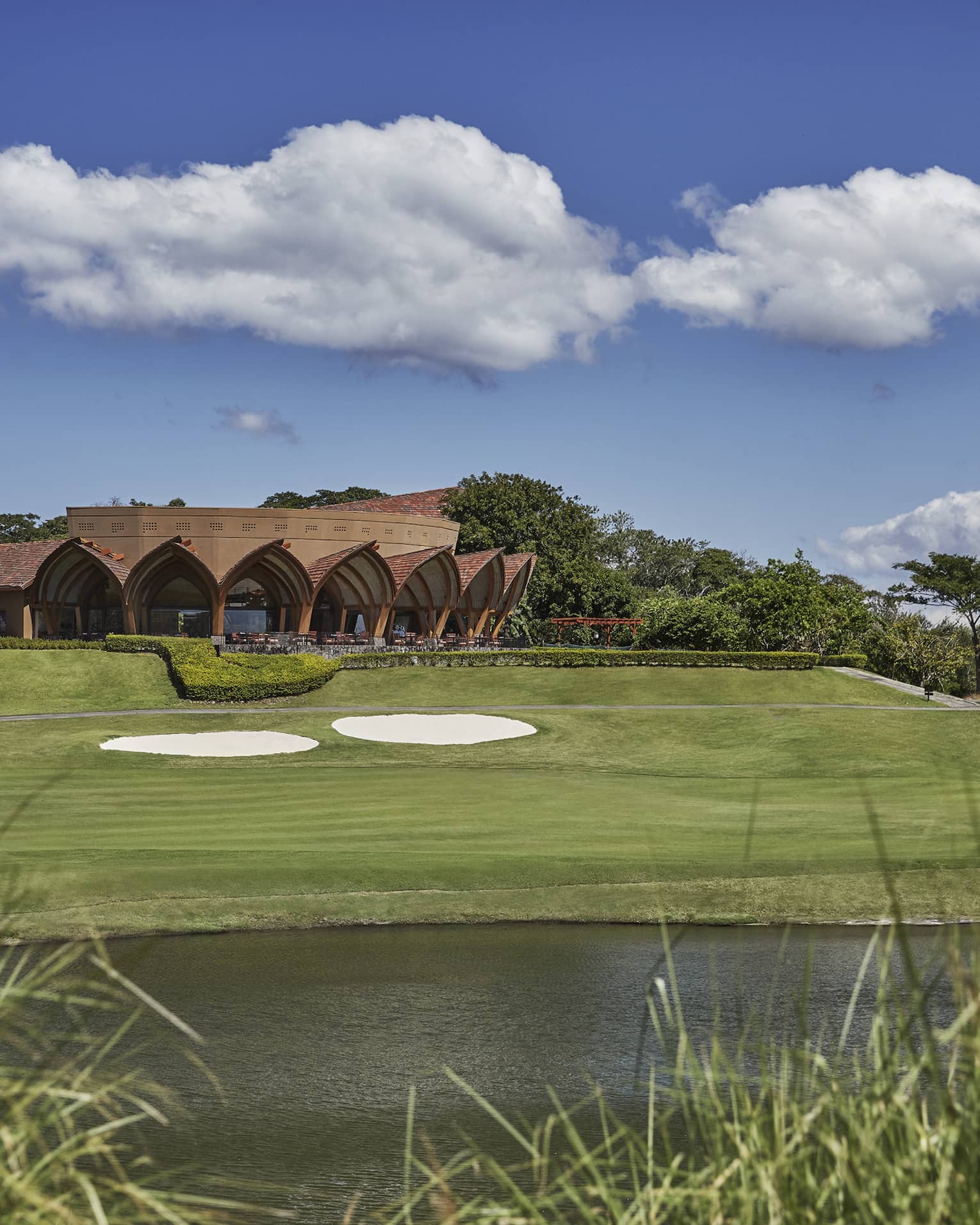 Sprawling golf course in Costa Rica with lake and tall grasses