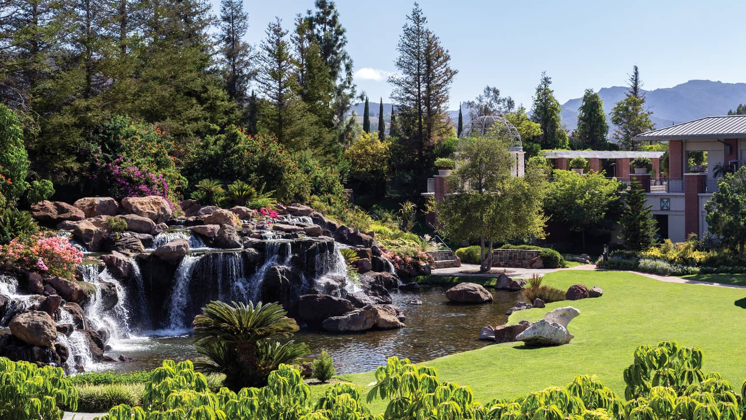 Waterfalls over rocks, boulders in garden at Four Seasons Hotel Westlake Village