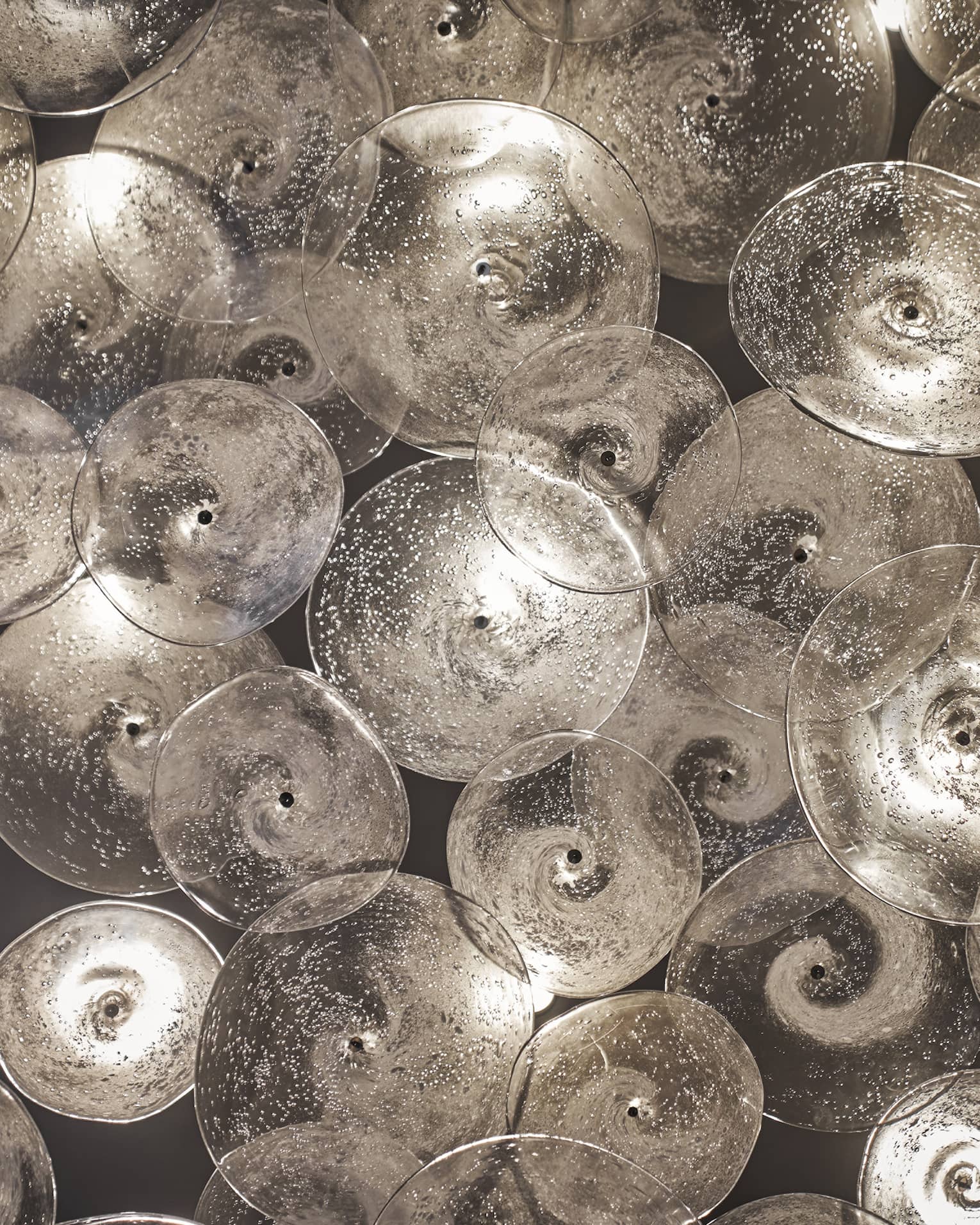 Glass sculptures, clear discs with swirls