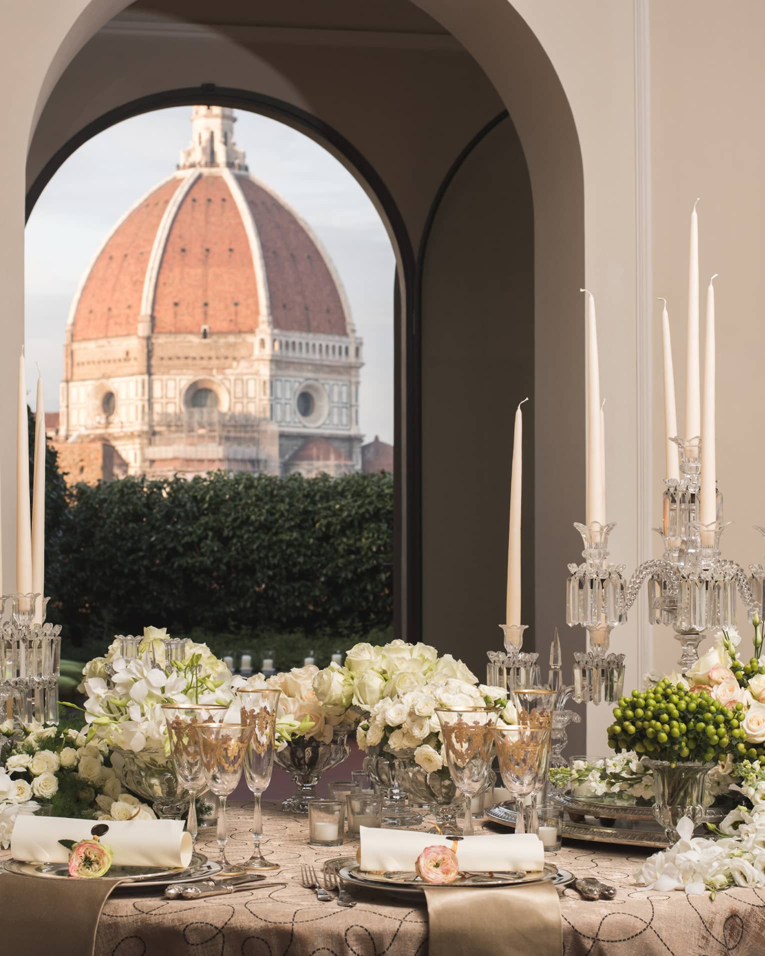 White roses, flowers on elegant banquet table under pillows, Duomo views