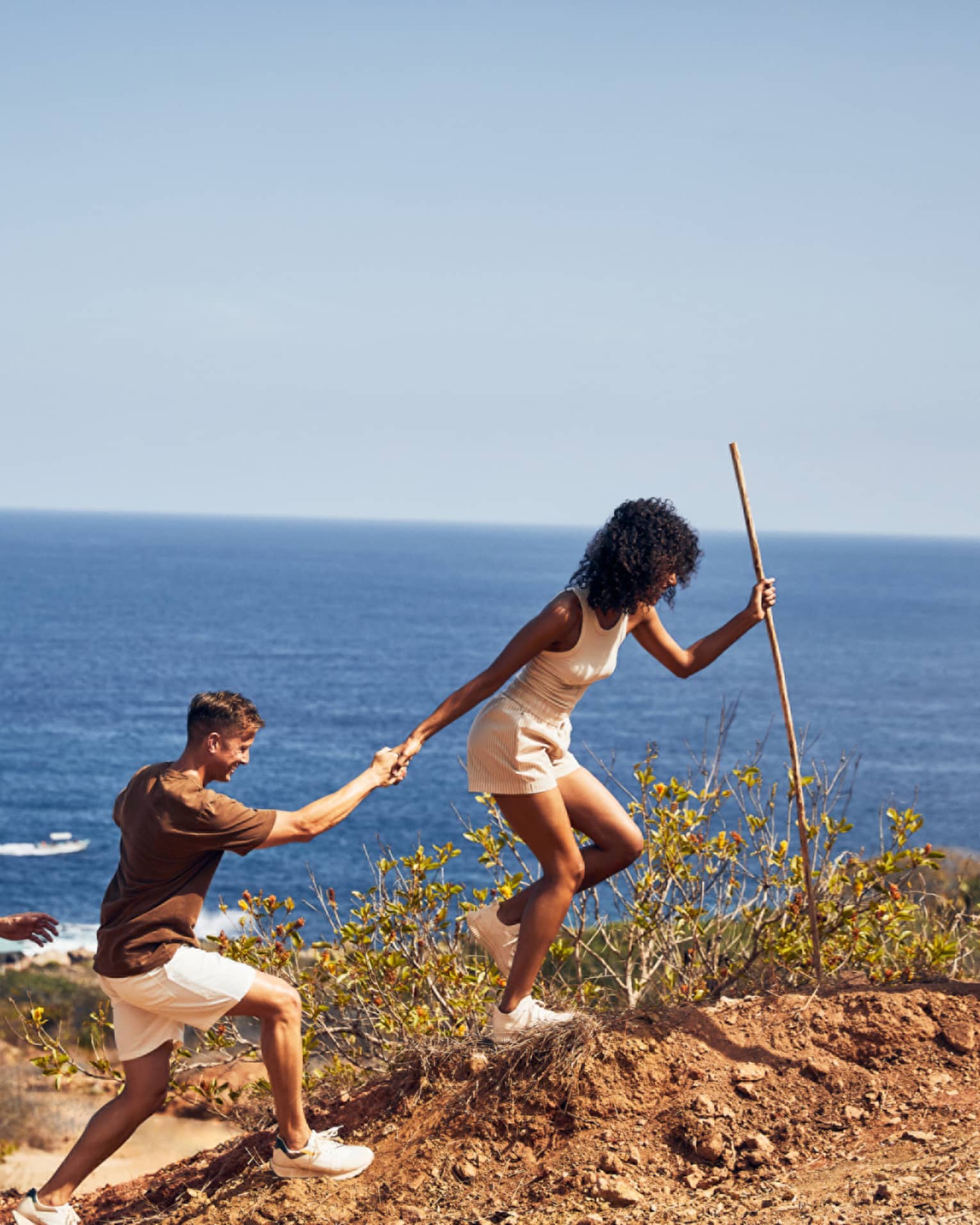 A group of people hiking along a beach.