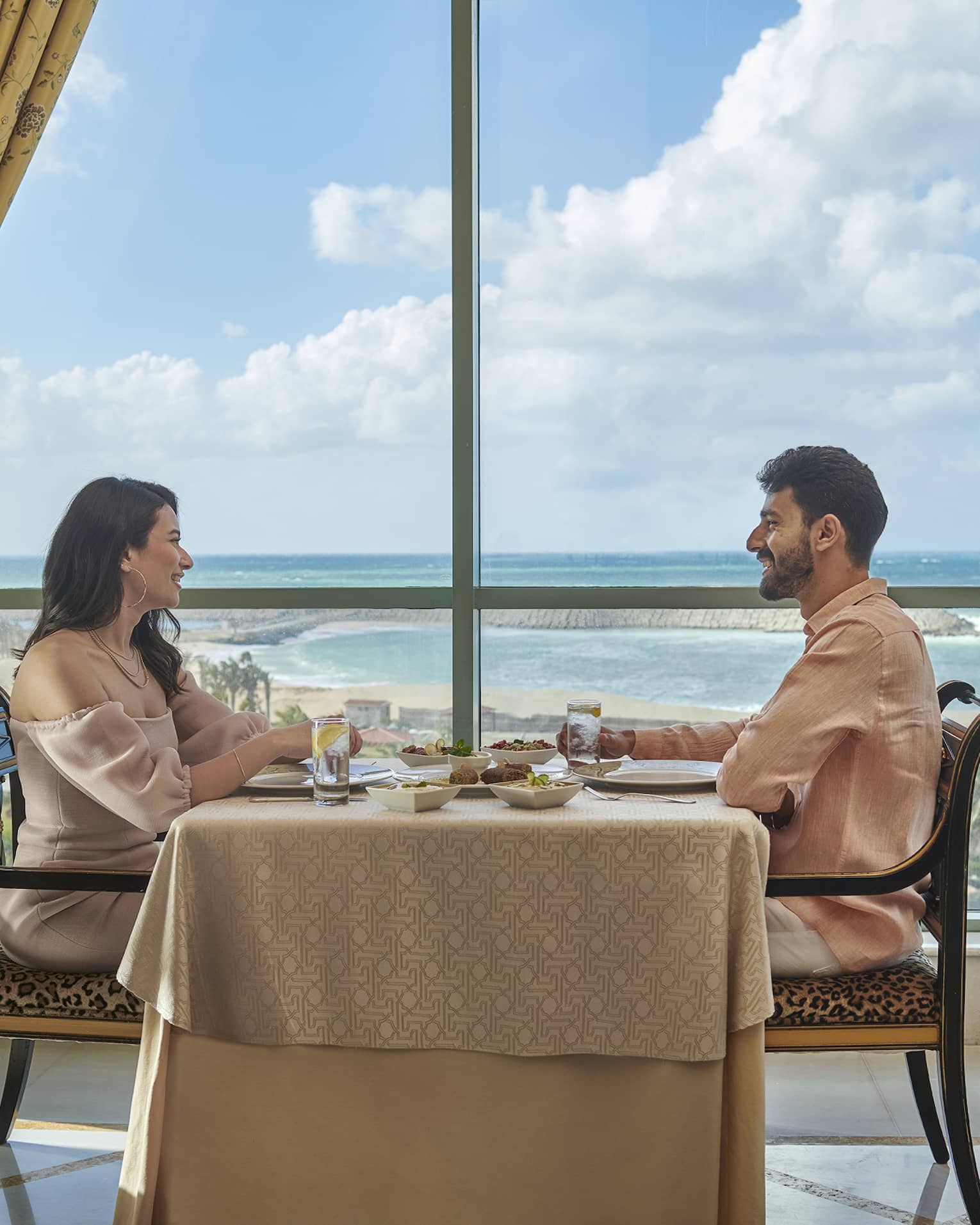 Couple enjoys a meal at Byblos Restaurant with views of the Mediterranean Sea
