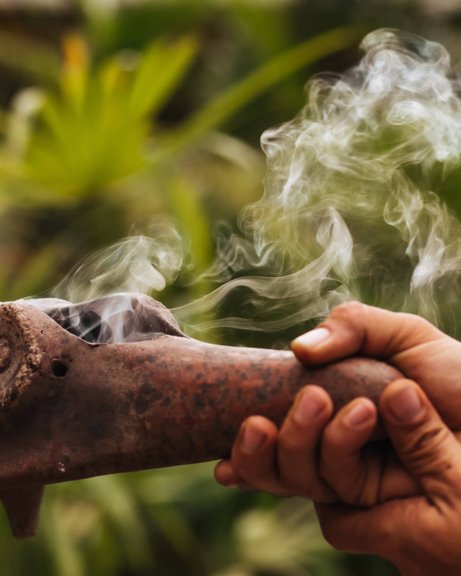 Smoke emerges from traditional Mayan copal pipe