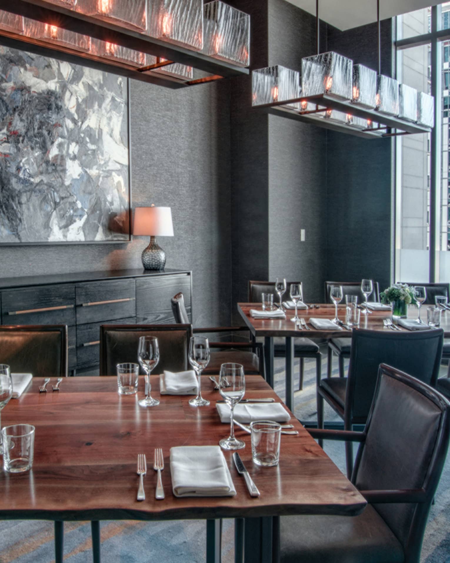 Goldfinch Tavern dining room with rustic wood table, grey chairs and decor