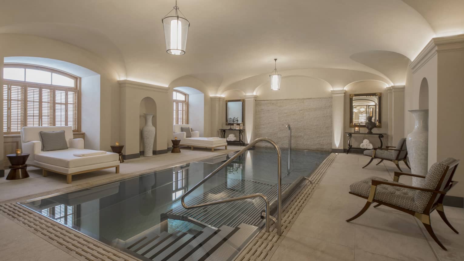 AVA Spa vitality pool  flanked by white lounge chairs under domed ceiling