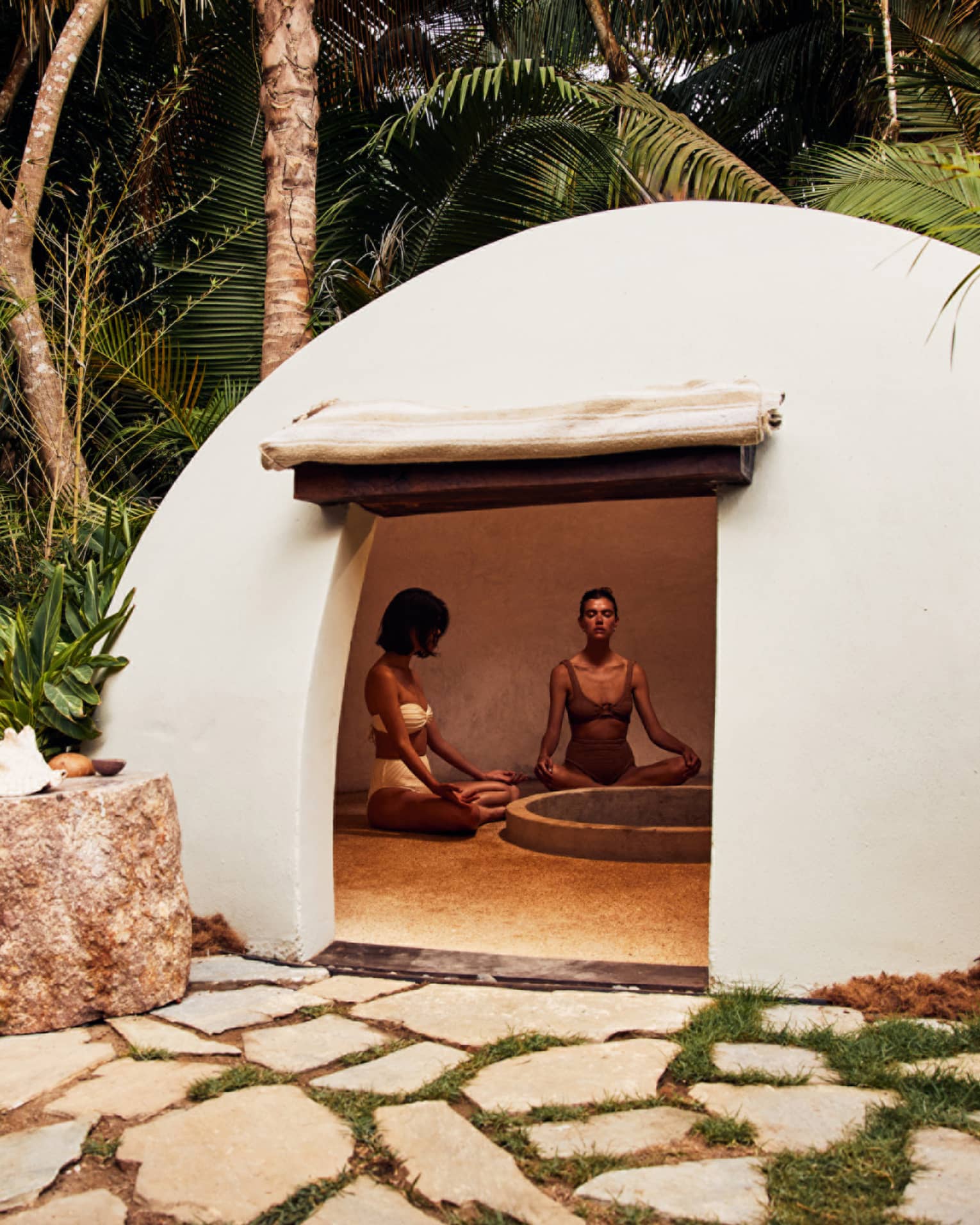 A heated dome shaped room surrounded by trees.