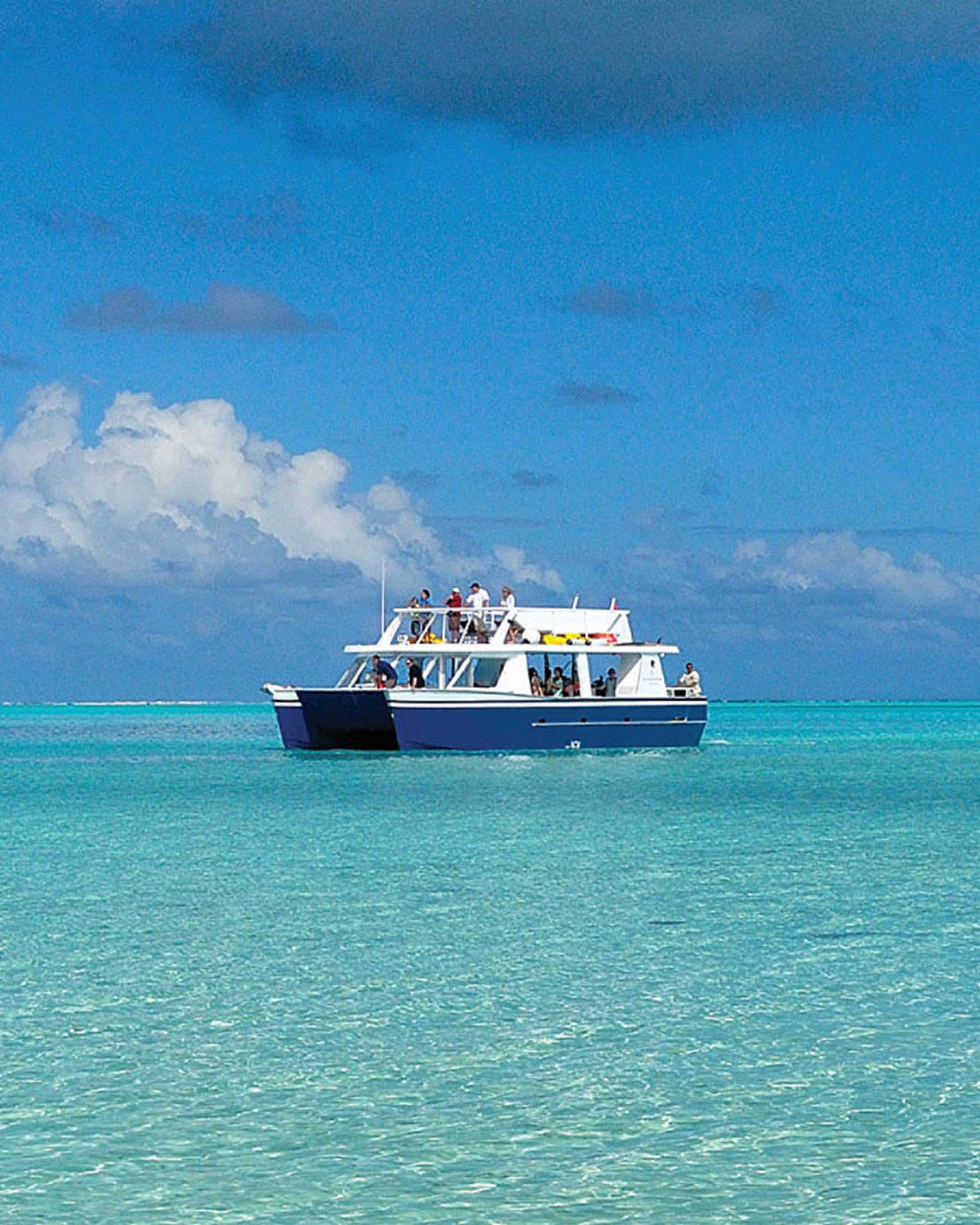 Guests on Four Seasons catamaran boat on lagoon