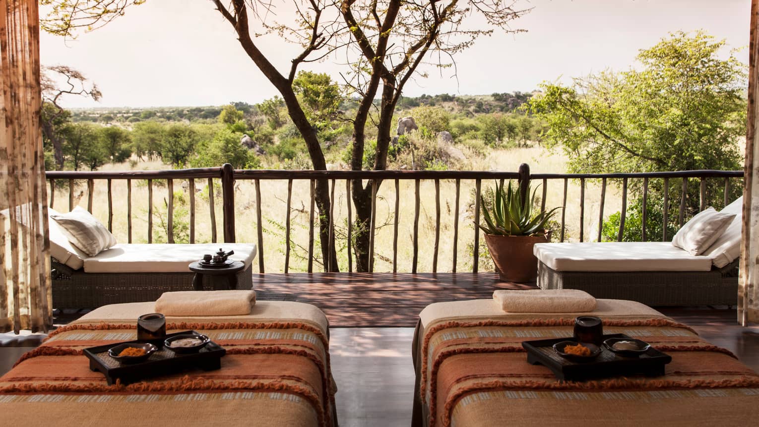 Spa couples massage beds with trays side-by-side in front of patio