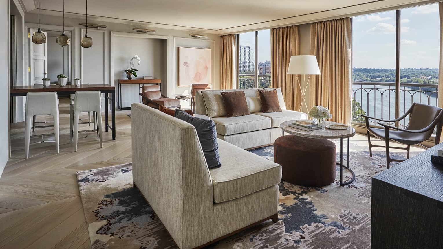 Hotel room dining stools, seating area by room-length floor-to-ceiling windows