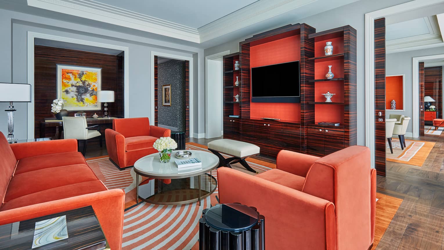 State Suite with warm orange velvet sofa and chairs, round coffee table, TV cabinet