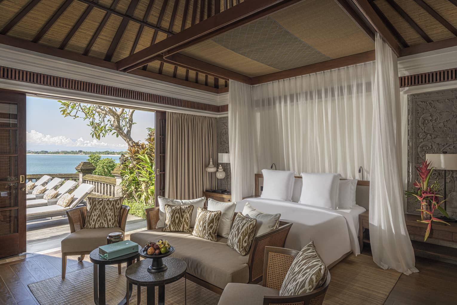 Royal Villa bedroom with canopy bed, doorway to pool and lounge area