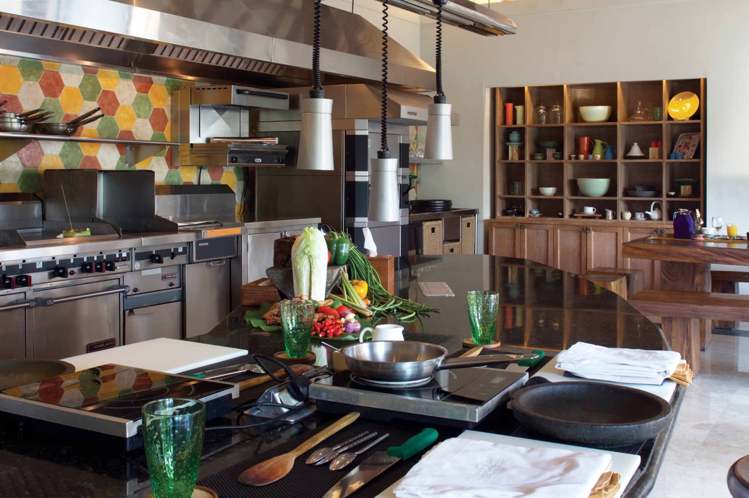 Jala Cooking Academy class station, table with hot plates, pans near stoves