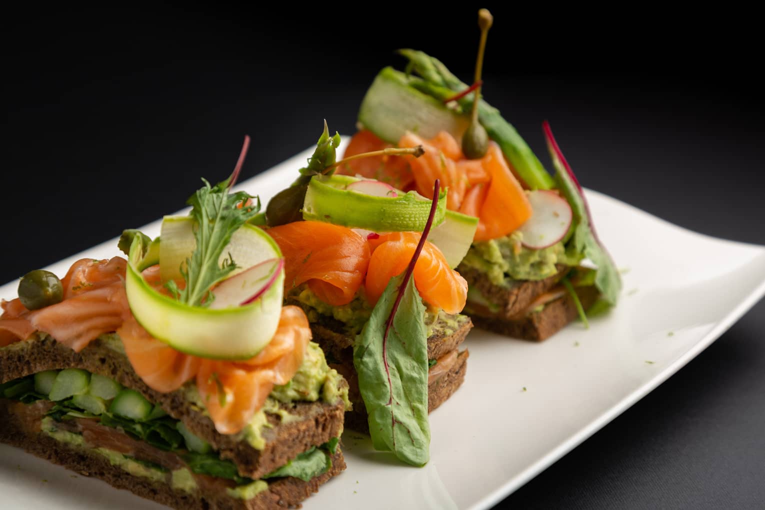 Scottish smoked salmon club sandwich with avocado, sucrine lettuce and radish