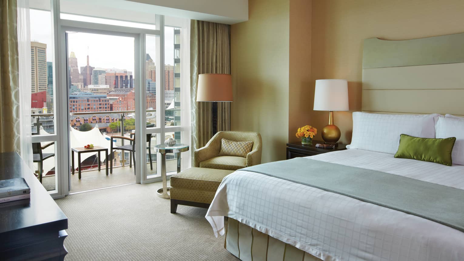 Suite featuring a king-size bed, plush seating and waterfront views.