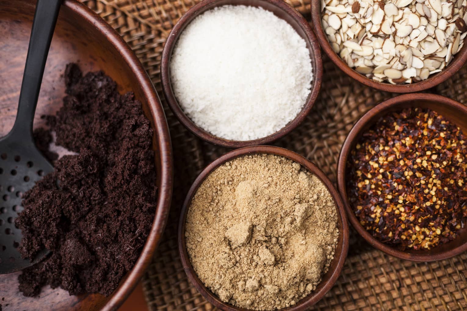 Small bowls of ground roasted cocoa beans, sugar, red chiles 