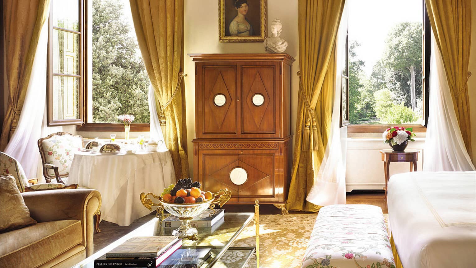 Renaissance Suite seating area, wood dresser, bright windows under dome ceiling, mural