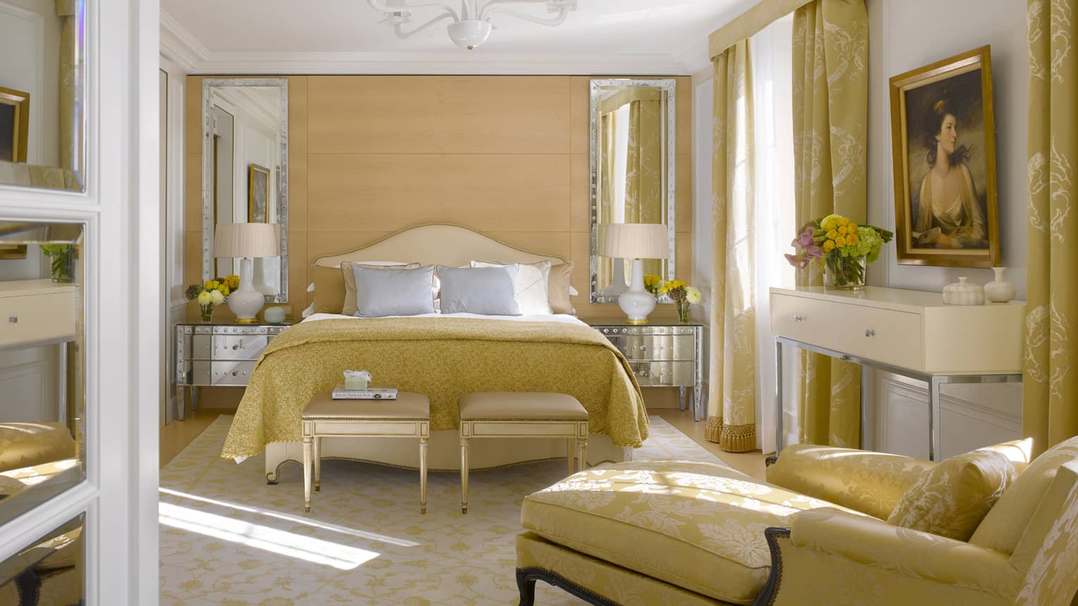 Bedroom with yellow-gold upholstery, chaise lounge and french doors