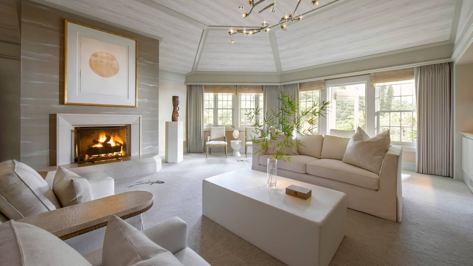 Guest suite living room with white couch and fireplace