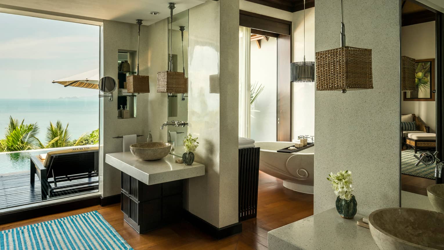 Villa bathroom with double marble sinks, freestanding tub, floor-to-ceiling window
