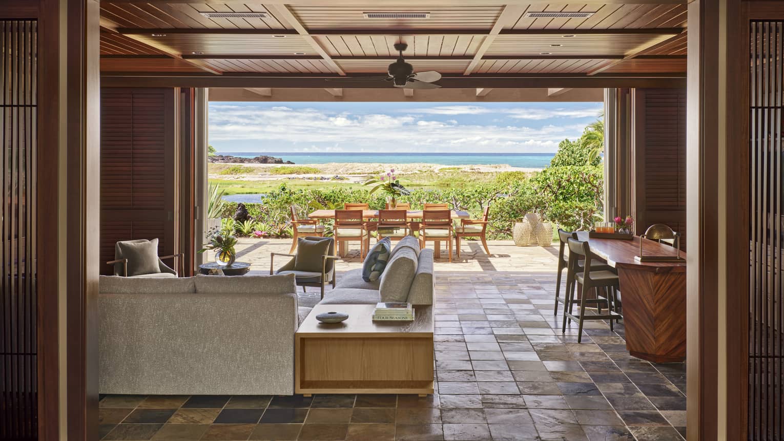 Living area with tile floor, opening up to outdoor terrace