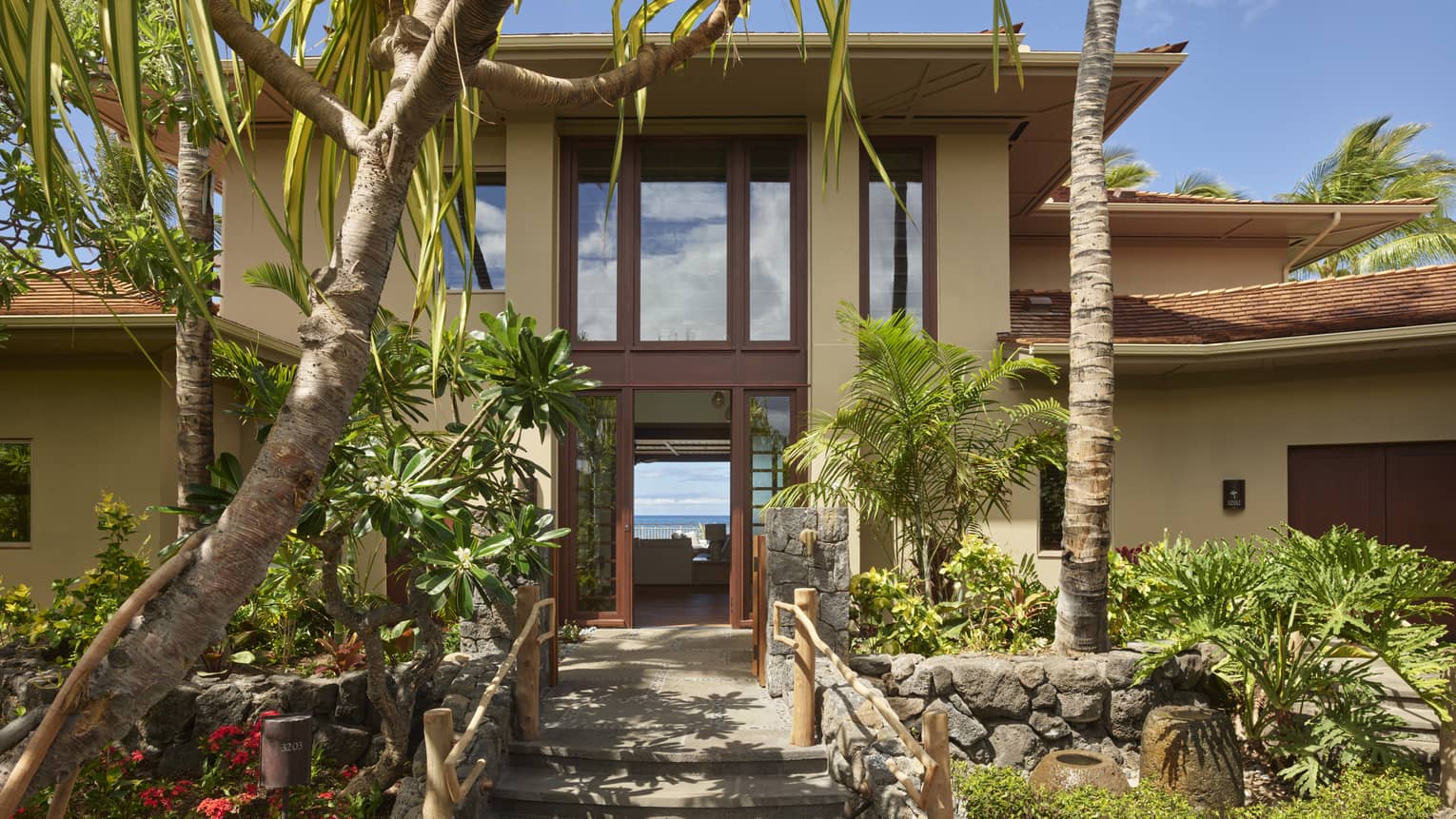 Exterior of villa with palm tree landscaping