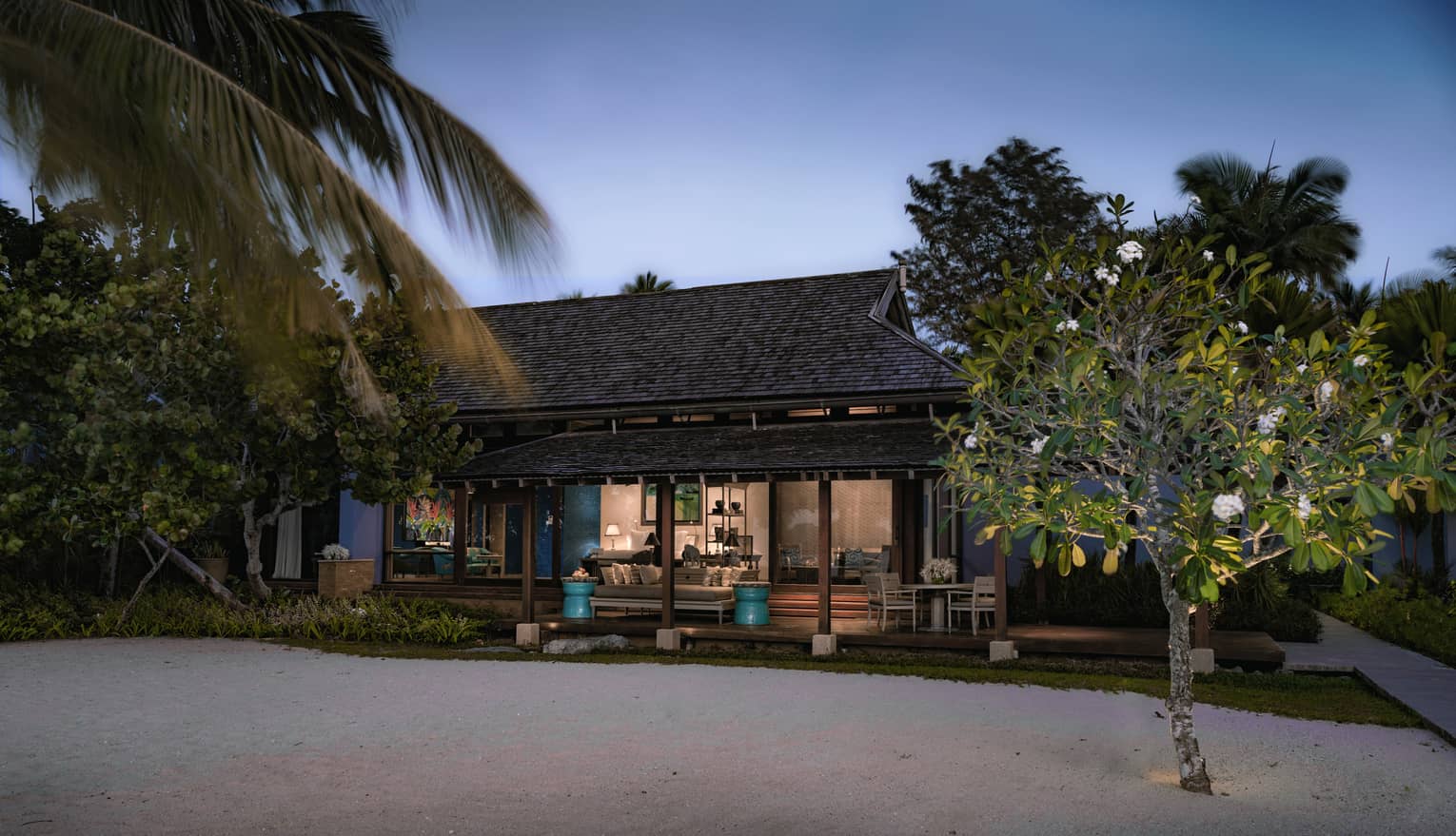 Deluxe Family Beach exterior at night with lights from sandy beach