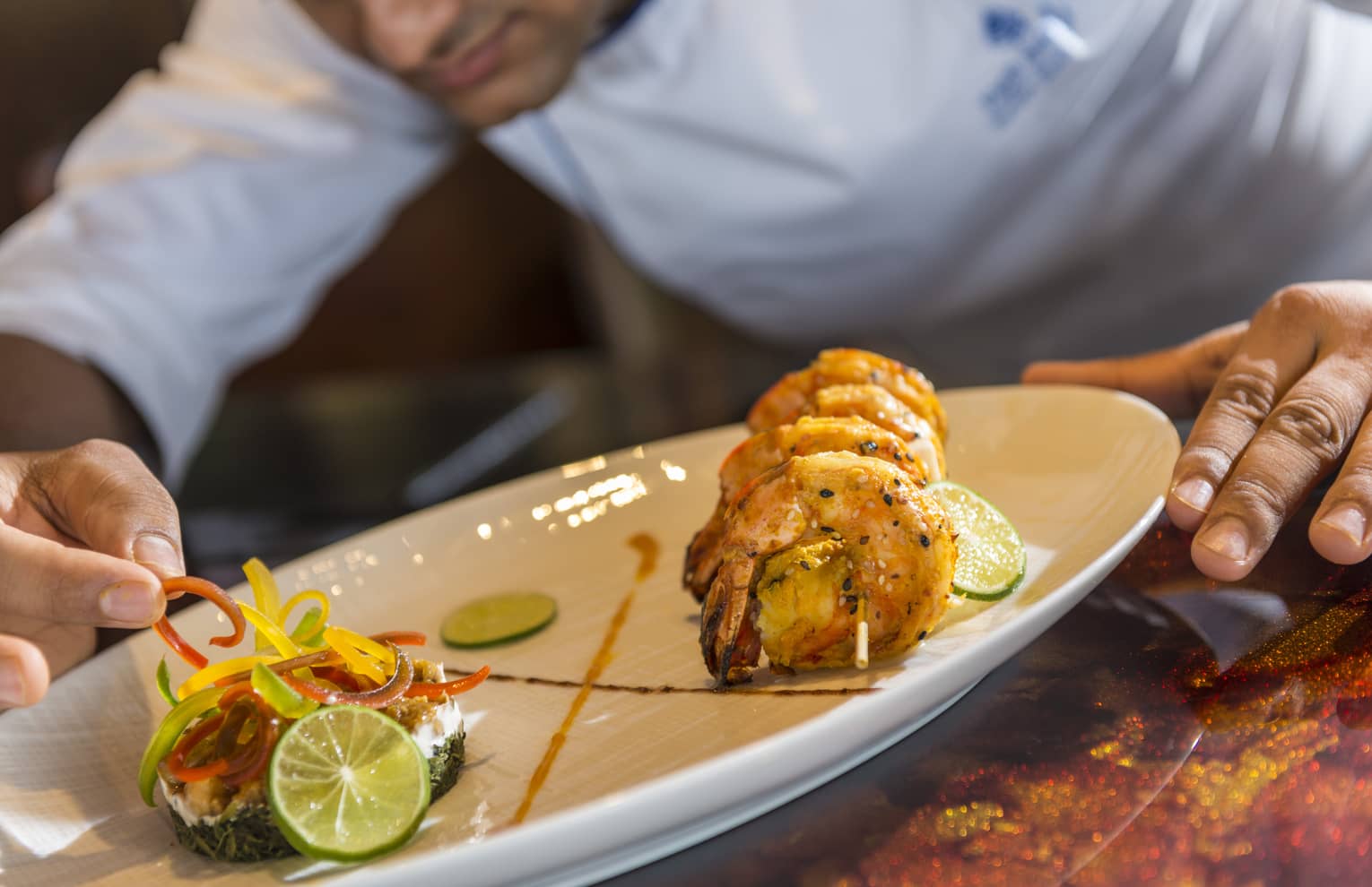 A chef plates some Baraabaru - Malabar Prawns