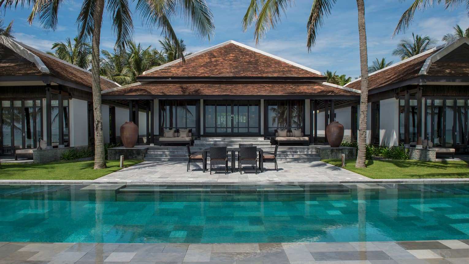 View of Ocean View Pool Villa exterior, patio under palms, from outdoor pool