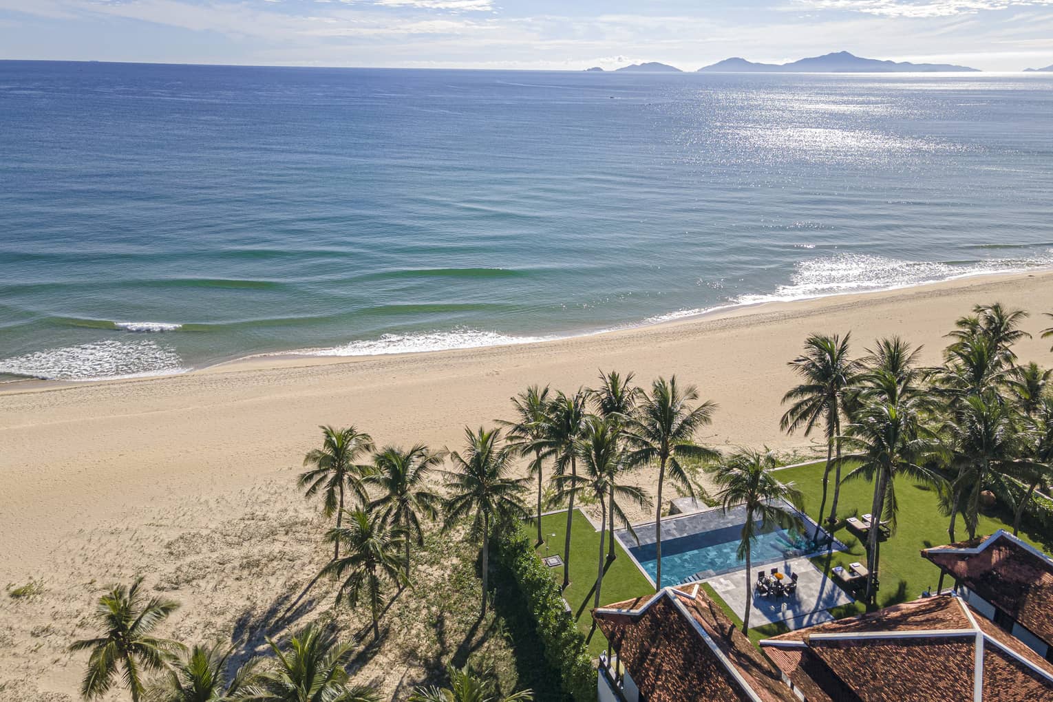 Three Bedroom Beachfront Pool Villa aerial view with ocean views and palm trees